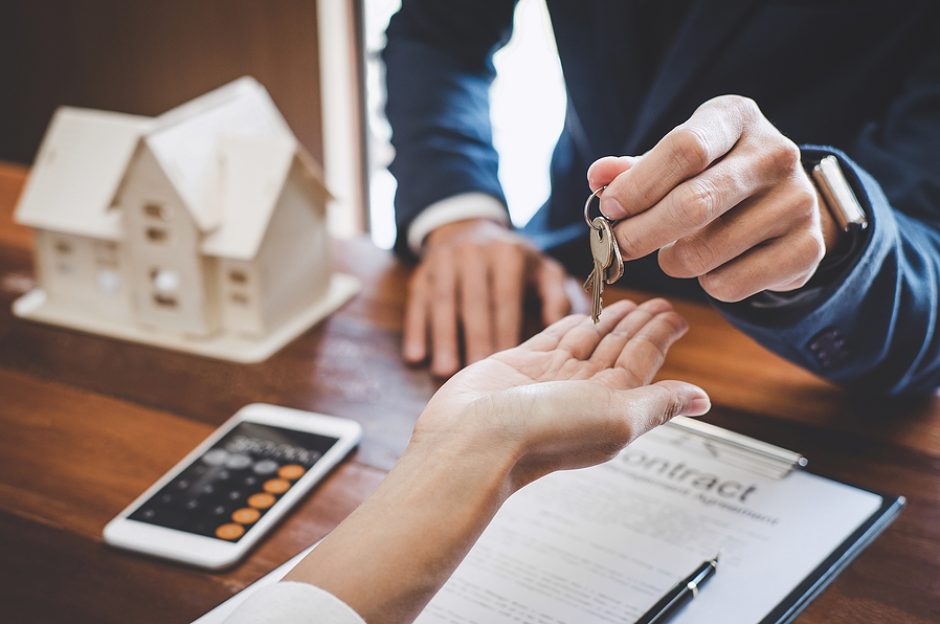 Real estate agent Sales manager holding filing keys to customer after signing rental lease contract of sale purchase agreement, concerning mortgage loan offer for and house insurance.